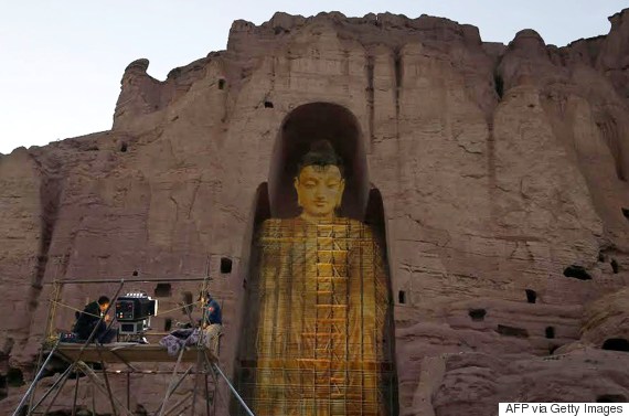This photo taken on June 7, 2015 shows the projected image of a Buddha statue in Bamiyan that had been destroyed by the Taliban in 2001. The initiative to visually restore the destroyed antiquities was dreamt up by Chinese couple Zhang Xinyu and Liang Hong, who are travelling through countries on the historic Silk Road route.  AFP PHOTO / Kamran Shafayee        (Photo credit should read KAMRAN SHAFAYEE/AFP/Getty Images)